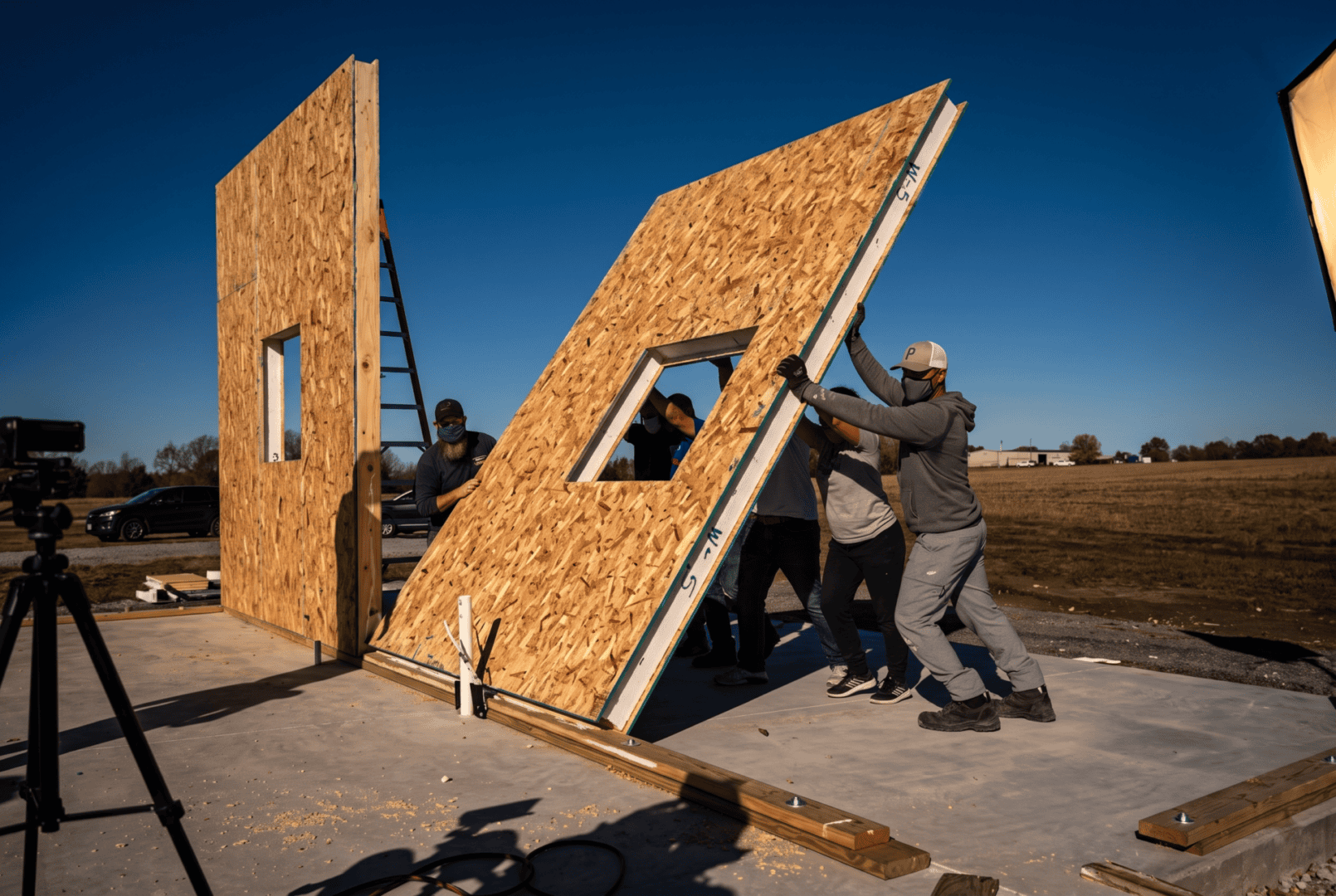 Structural insulated panels (SIPs) being raised into place on a Struxa home